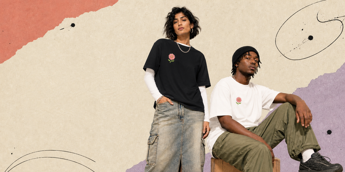 Two models posing in a studio setting with an abstract, textured beige background. The model on the left wears a black crewneck t-shirt with a small red rose graphic over a white long-sleeve shirt and a denim skirt.